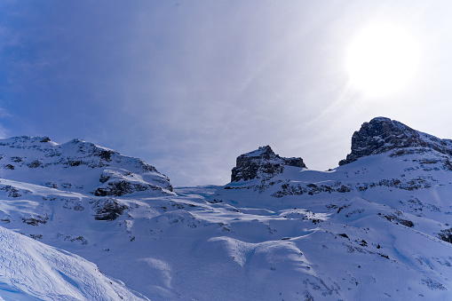 Scenic view of mountain panorama with snow covered mountain peaks in the Swiss Alps at mount Titlis on a sunny winter day. Photo taken February 21st, 2024, Titlis, Engelberg, Switzerland.