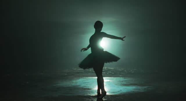 Silhouette of Ballerina performing, dancing, spinning in spotlights, Slow motion.