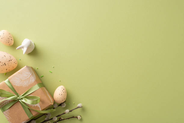 istock Homestead Easter layout design. Overhead capture of crafty box presentation, bunny, patterned quail eggs, cake decor, blooming pussy willow, all arranged on green surface with dedicated spot for ad 2030247725