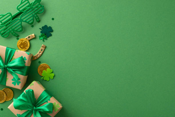 istock Dreamy St. Patrick's setup viewed from top, with shamrocks, mythical cap, fortune's coins, gift packages, carnival eye wear, good-fortune horseshoe, and sparkles, on a green backdrop, space for text 2030247748