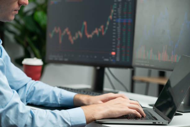 istock Working young business trader focusing stock graph on laptop. Gusher. 2030256196
