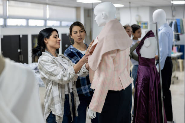 istock Fashion design student showing the teacher her progress with a jacket 2030273131