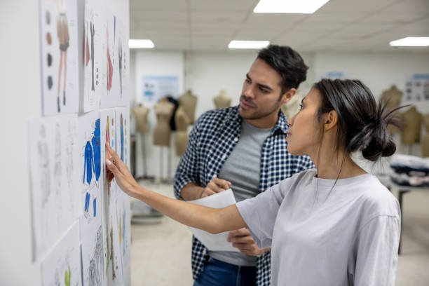 istock Fashion design student explaining her designs to her teacher in class 2030273187