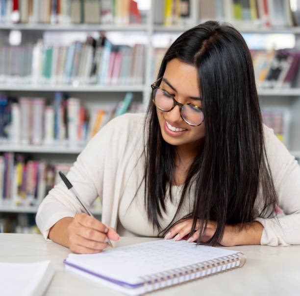 istock Woman studying at the library 2030273703