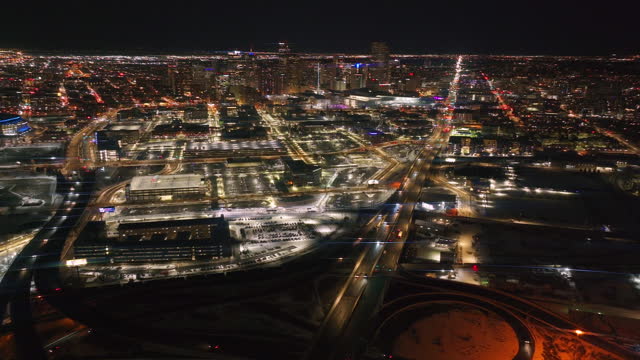 Denver downtown i25 highway traffic aerial drone cinematic anamorphic snowy winter evening dark night city lights landscape Colorado Mile High Pepsi Center  Ball arena Broncos forward motion