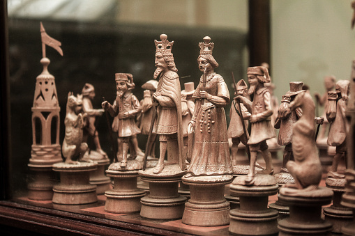 Artistic chess pieces carved in light wood.