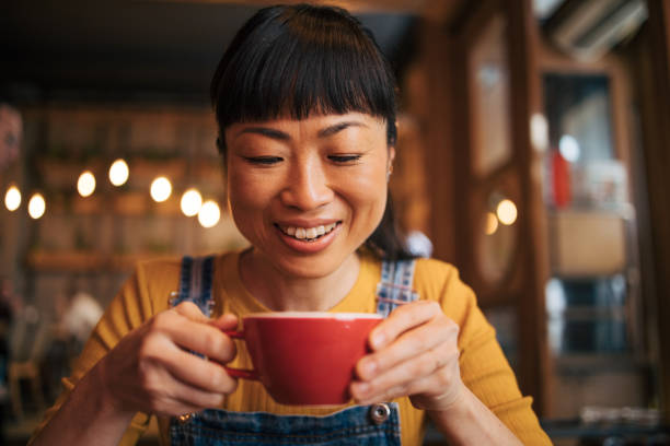 istock A woman drinks a cappuccino in a cafe. 2030291276