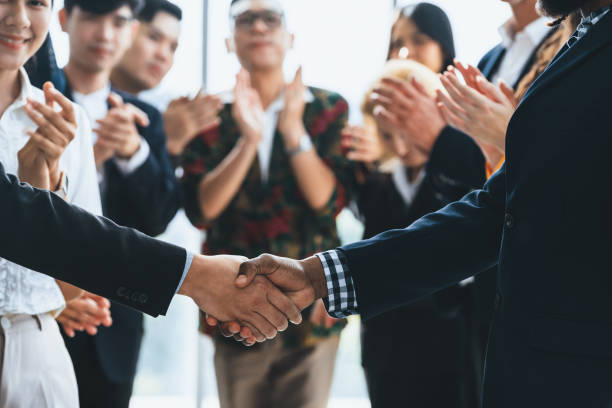 istock Cropped image of smart businessmen shaking hand, making agreement. Intellectual. 2030292895