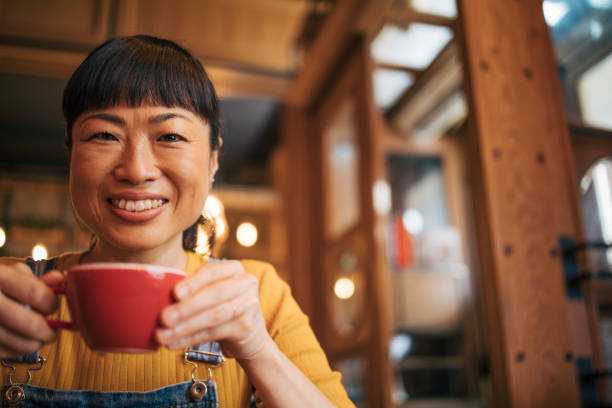 istock A woman drinks a cappuccino in a cafe. 2030294417