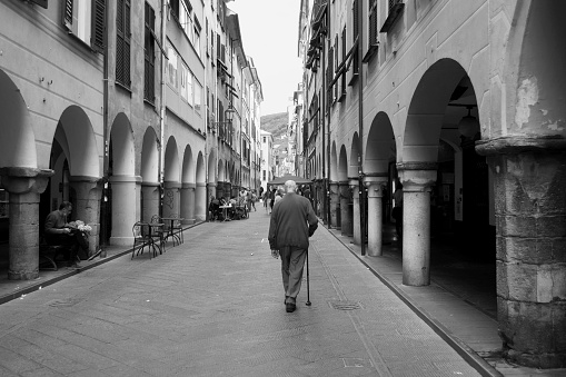 An Elderly Man Walking in Chiavari Old Town, Genova Province, Italy. Black and White Photography