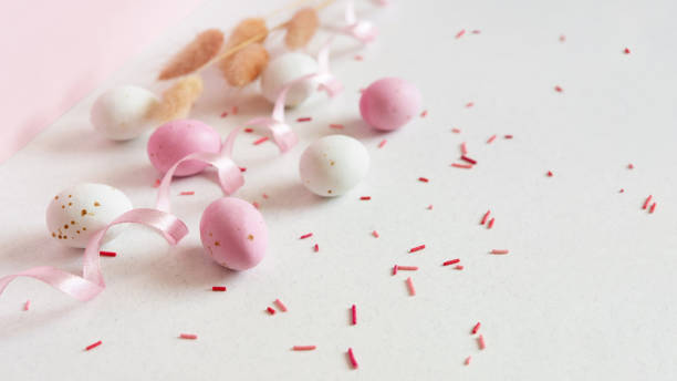 istock Easter minimalistic concept with easter eggs, ribbon and flowers. Delicate pastel empty background with copy space. 2030309796