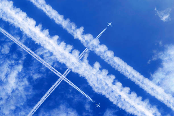istock vapor trails and passenger jets high in the sky 2030312581