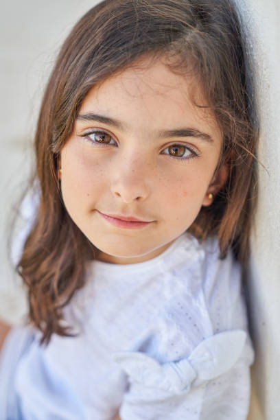 charming unemotional girl looking at camera - child blank expression pensive focus on foreground imagens e fotografias de stock