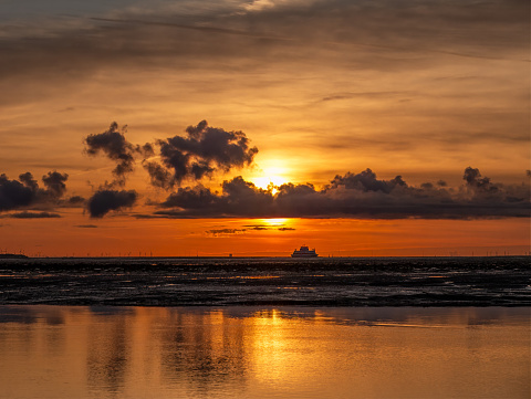 Sunrise view from Amrum with ferry, Waddensea, North Frisia, Schleswig-Holstein, Germany
