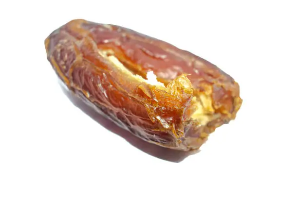 Date fruit without seed on white background