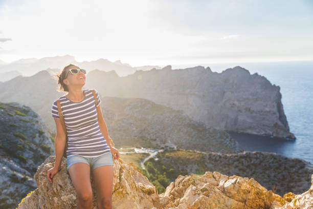 istock Smiling woman enjoying scenic coastal view 2030337919