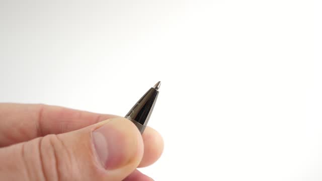 The ballpoint ink pen protrudes from the pen body. Stationery.