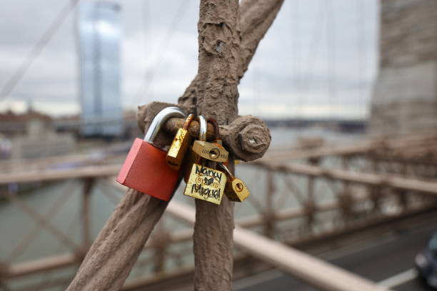 Love locks, or padlocks inscribed with couples' names or initials are attached to the Brooklyn Bridge in New York, N.Y., Saturday, Jan. 27, 2024. The practice has been banned on the bridge as the weight of the locks can cause structural damage to the bridge and pose a safety risk. (Photo: Gordon Donovan)