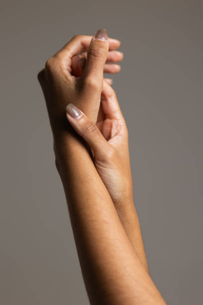 Woman moisturising hands close-up