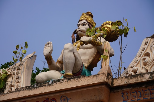 statue of god hanuman ji on the top of temple