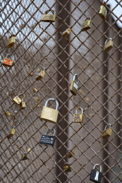 Love locks, or padlocks inscribed with couples' names or initials are attached to the Brooklyn Bridge in New York, N.Y., Monday, Jan. 15, 2024. The practice has been banned on the bridge as the weight of the locks can cause structural damage to the bridge and pose a safety risk. (Photo: Gordon Donovan)
