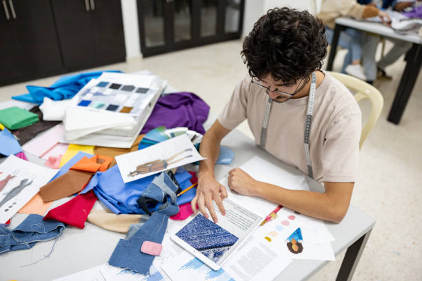 istock Fashion student learning about fabrics in a textile class at university 2030353204