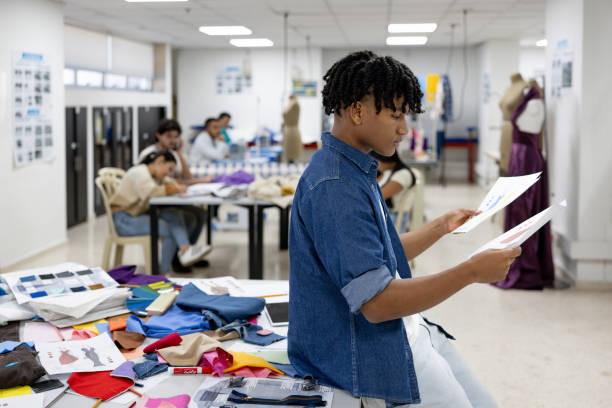 istock Design student looking some sketches at a fashion atelier 2030353217