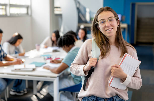 istock Portrait of a happy student at the library 2030353224
