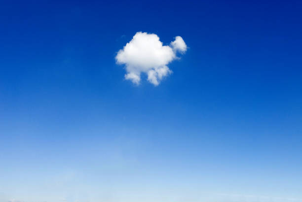 istock one single small fluffy white fair weather cloud in blue sky 2030353271