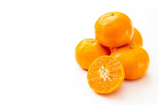 Mandarin oranges on a white background.