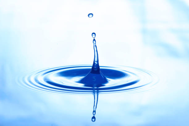 istock a drop of water jumps upwards from the water surface 2030358990
