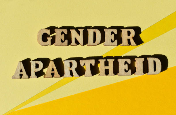 Gender Apartheid, phrase as banner headline Gender Apartheid, words in wooden alphabet letters isolated on yellow background as banner headline apartheid sign stock pictures, royalty-free photos & images