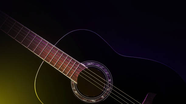 istock black guitar front view close-up. black guitar in the dark 2030375119