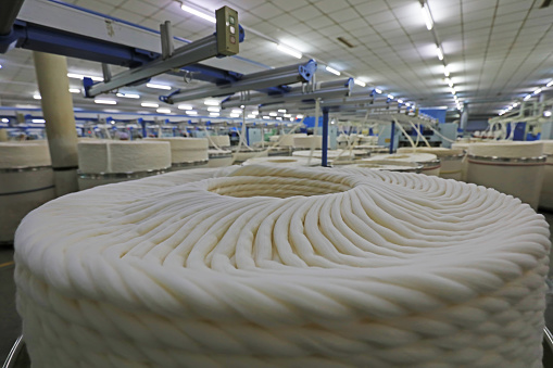 The cotton yarn on the production line is in a spinning factory