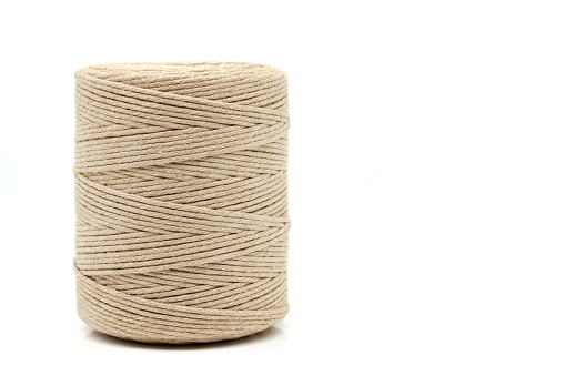 A spool of natural cotton twine with a wide range of applications. Selective focus with shallow depth of field.