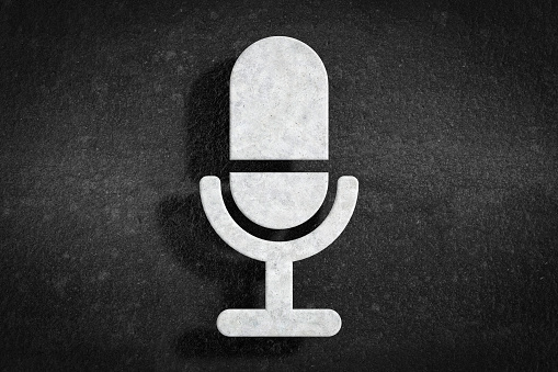 Grunge White Stone Microphone Icon on a Dark Grunge background. 3d Rendering