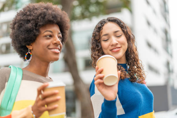 istock Friends talking and drinking coffee while going to college 2030409940