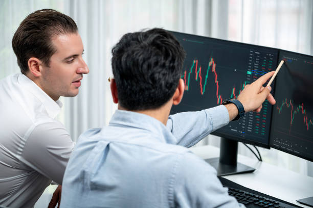 istock Investor stock office worker analyzing investment on dynamic graph. Sellable. 2030413132