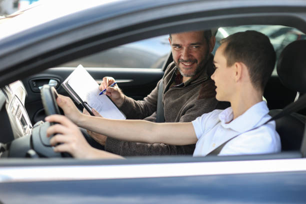 Car school Male teenager learning how to drive a car. About 18 years old, Caucasian male and a male driving instructor. teenager boy driving stock pictures, royalty-free photos & images