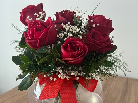 Close up of Red Roses in vase on the table