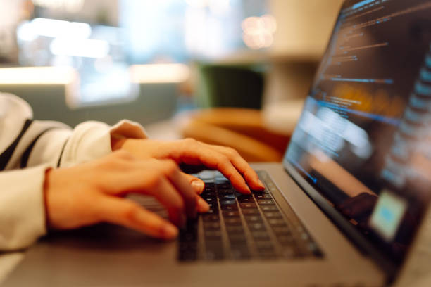 istock Close-up of hands working on a laptop keyboard. 2030431680
