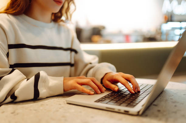 istock Close-up of hands working on a laptop keyboard. 2030431684