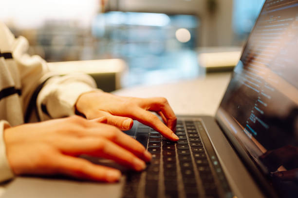 istock Close-up of hands working on a laptop keyboard. 2030431775