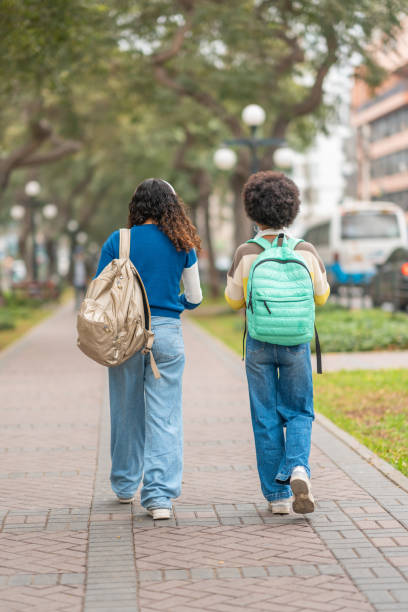istock Female students carrying their backpacks on their backs 2030432939