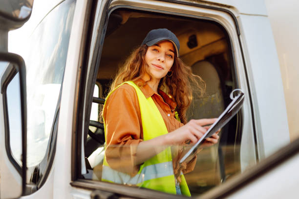 istock Young woman sits in a cargo truck 2030442285