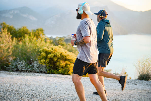 istock Two best friends walking and doing sports on the beach 2030451054