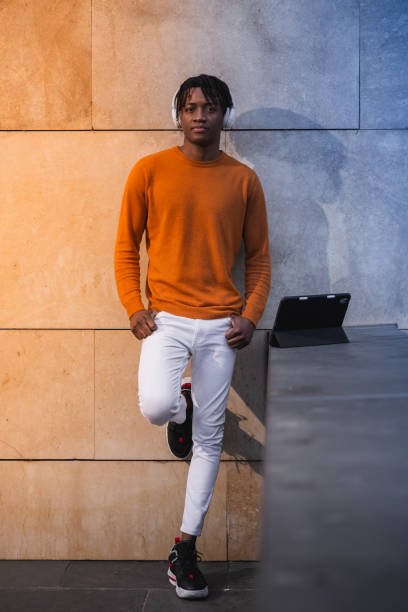 istock Young man engages with a tablet, immersed in the digital world amidst the architectural elegance of a cityscape. 2030455914
