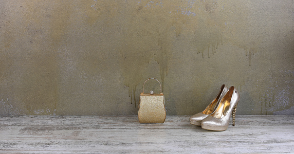 gold high heels and gold handbag