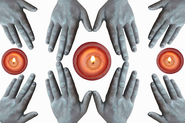 Hands joined for a session of spiritualism  Lighted candles