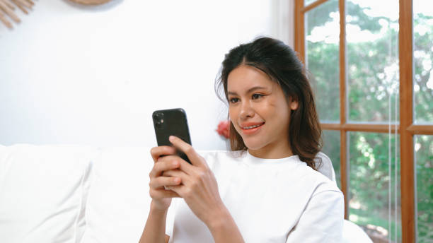 istock Young woman using smartphone browsing for online shopping E commerce by online payment gateway at vivancy home. Modern and convenience online purchasing make secure and convenient purchases. 2030471951